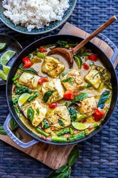 a pan filled with tofu and vegetables next to rice