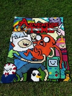 the adventure time blanket is laying on the grass