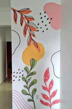 an abstract painting on the side of a wall with leaves and flowers painted on it