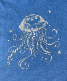 a blue t - shirt with an image of a jellyfish on it