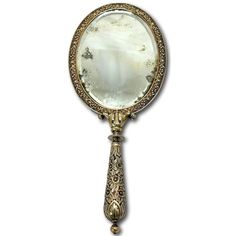 an antique looking mirror on a white background