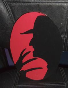 a black and red sticker with a man's face on it