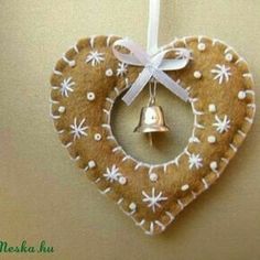 a gingerbread heart ornament with a bell hanging from it's side