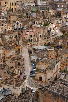 an aerial view of a city with lots of buildings and cars parked on the street