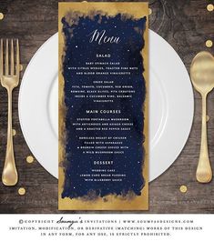 a menu with gold foil on it next to a white plate and silver utensils