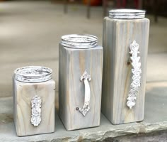 three canisters sitting on the ground next to each other