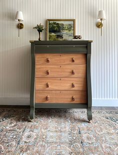 a dresser with drawers and two lamps next to it