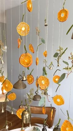 orange slices hanging from strings in a room with other items on the table and around them