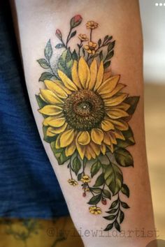 a sunflower with green leaves and yellow flowers on it's arm is shown