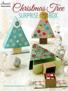 the christmas tree surprise box is made from cardboard and decorated with ornaments, ribbons and bows