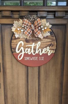 a wooden door with a sign that says gather somewhere else