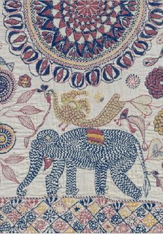 an elephant is depicted in this intricately designed wall hanging