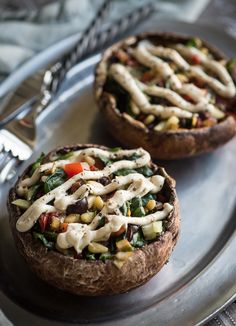 two baked goods on a plate with silverware