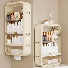 a bathroom with two shelves on the wall and one shelf above the toilet that is filled with personal care products