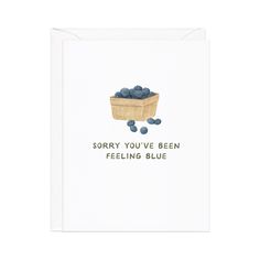 a card that says sorry you've been feeling blue berries in a wooden box