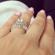 a woman's hand with a diamond ring on it