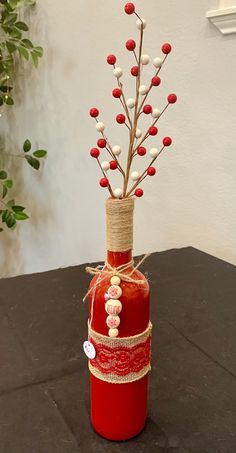 a bottle filled with red and white decorations