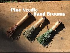 three different types of hand brooms sitting on top of a piece of wood with the words pine needle hand brooms