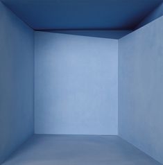 an empty room with blue walls and no one in it