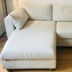 a white couch sitting on top of a hard wood floor