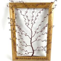 a wooden frame with a wire tree in it