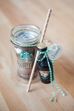 there is a glass jar with some coffee in it and two straws next to it