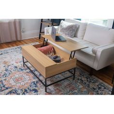 a living room with a couch, coffee table and rug