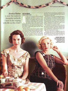 two women sitting at a table in front of a wall with buns on it