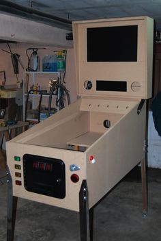 an old fashioned arcade machine sitting in a garage