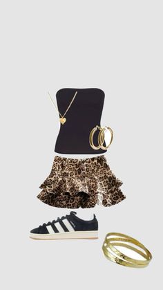 a black top, leopard print skirt and sneakers with gold rings on the shoes are sitting next to each other