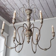 an old chandelier with candles hanging from it