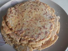 three pancakes on a plate with a fork