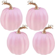 three pink glass pumpkins sitting next to each other