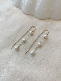 "These dainty Pearl threader earrings are classic and minimal. They look lovely paired with your special occasion outfits or a night out! The chain \"threads\" through the ear and stays in place!  Details: * Choose from 925 Sterling Silver or 14K Gold Filled * 5mm off round white Pearls * Approximately 2.25\" length * Made with all hypoallergenic materials 🤍 ✨ See all Pearl Jewelry here!: https://etsy.me/3zMbXyh WHAT TO KNOW ABOUT YOUR MAGBEE JEWELRY PURCHASE: 🤍 All MagBee pieces are safe for Dainty Chain Earrings, Delicate White Earrings With Adjustable Chain, Dainty White Pearl Drop Threader Earrings, White Dainty Pearl Drop Threader Earrings, White Dainty Threader Earrings With Pearl Drop, Minimalist Threader Earrings With Adjustable Chain For Wedding, Minimalist Wedding Threader Earrings With Adjustable Chain, White Adjustable Chain Dangle Threader Earrings, White Dangle Threader Earrings With Adjustable Chain