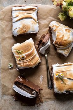 four pieces of cake with frosting and flowers