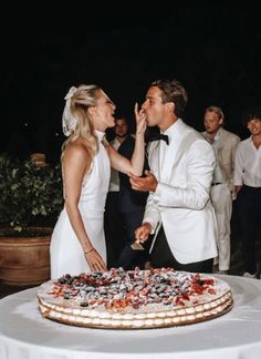 a bride and groom are about to cut their wedding cake at the end of the night