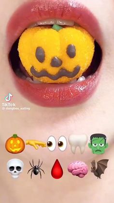 a woman's mouth with various halloween decorations on the top and bottom half of it