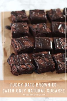 brownies with chocolate frosting are on a piece of parchment paper, ready to be eaten