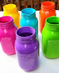 colorful mason jars lined up on a table