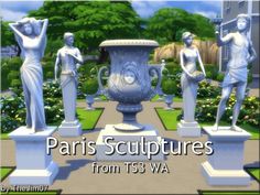 some statues are standing in front of a large vase and flowerbeds with trees behind them