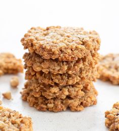 three cookies stacked on top of each other with crumbs scattered around the edges