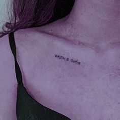 the back of a woman's shoulder with writing on it