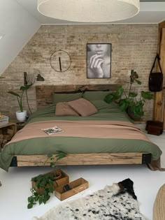 a bedroom with exposed brick walls and green bedding