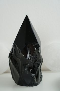 a black diamond sitting on top of a white table