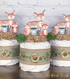 three diapers are stacked on top of each other and decorated with deers, leaves and flowers