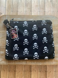 a skull and crossbones purse on a wooden table