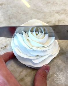 a metal bowl filled with white liquid on top of a counter