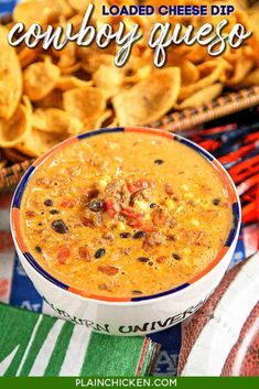 a bowl filled with soup next to chips and a plate full of tortilla chips