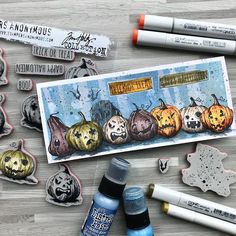 some stamps and markers are laying out on a table with pumpkins, jack - o'- lanterns, and other items