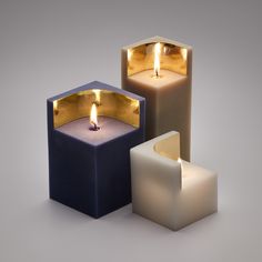 three lit candles sitting next to each other